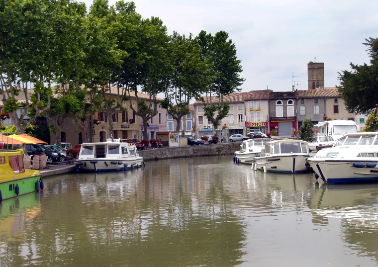 a marina with many boats and buildings along it