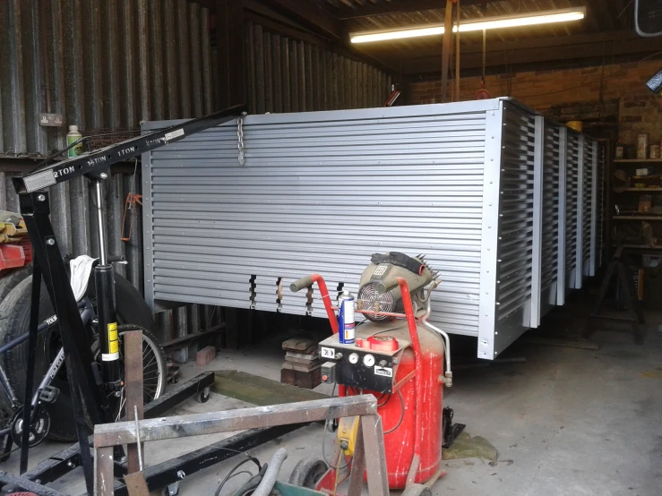 the interior of a garage filled with metal equipment