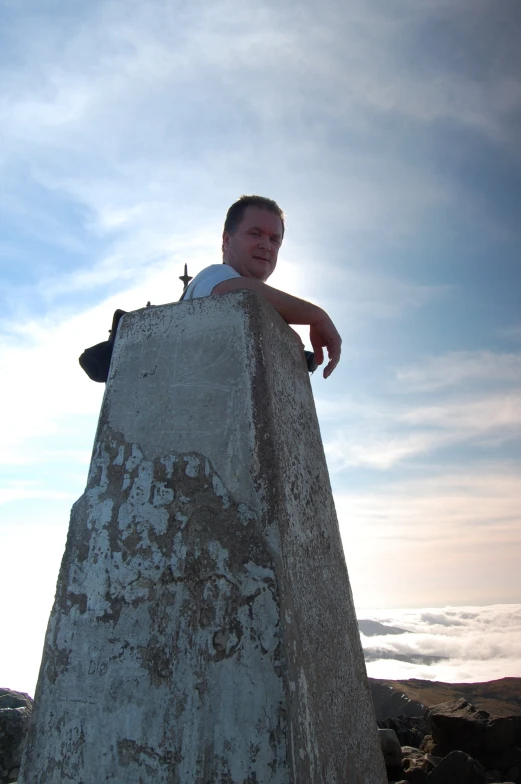 the man is standing on top of the monument