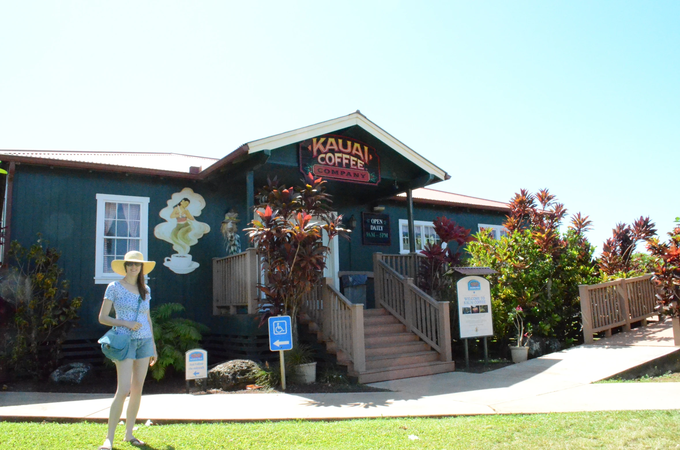 a woman in a straw hat is standing outside a blue restaurant