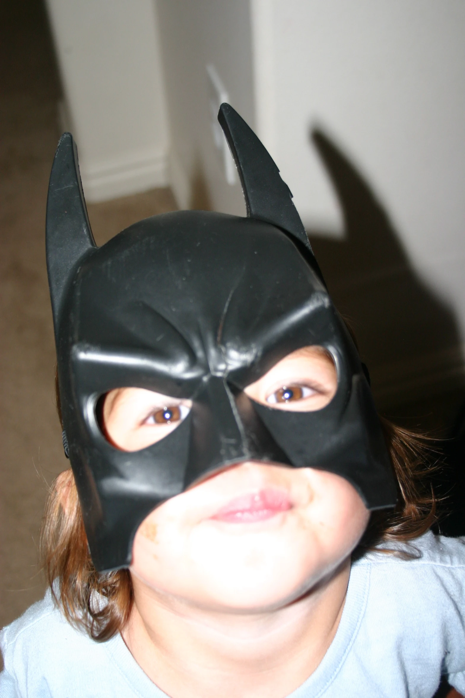 a  wearing a batman mask for the camera
