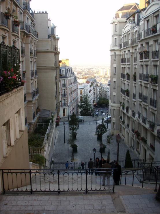 view down street from the top of a hill, looking towards an old city