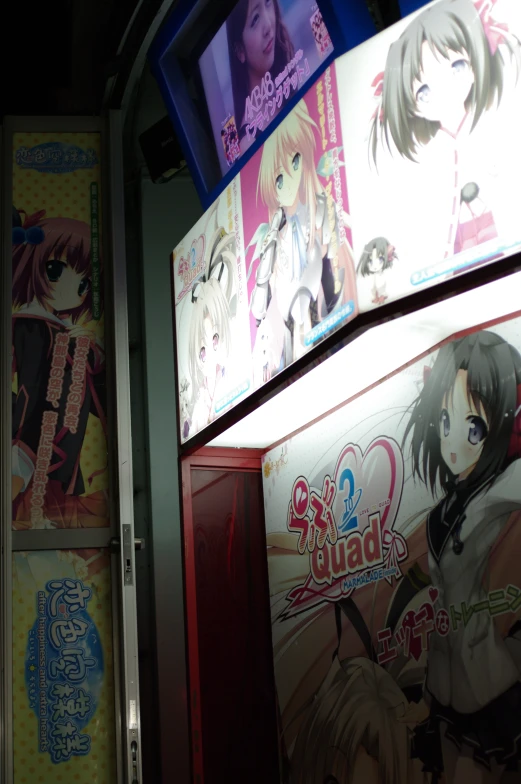 various anime posters and advertits on the wall