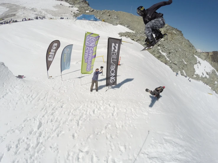 an image of snowboarding going down a snowy mountain slope