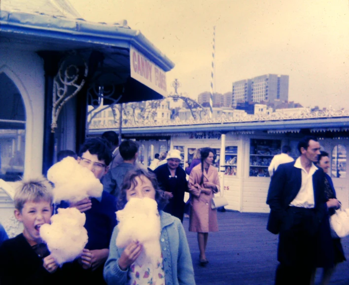 a crowd of people outside a carnival looking at soing