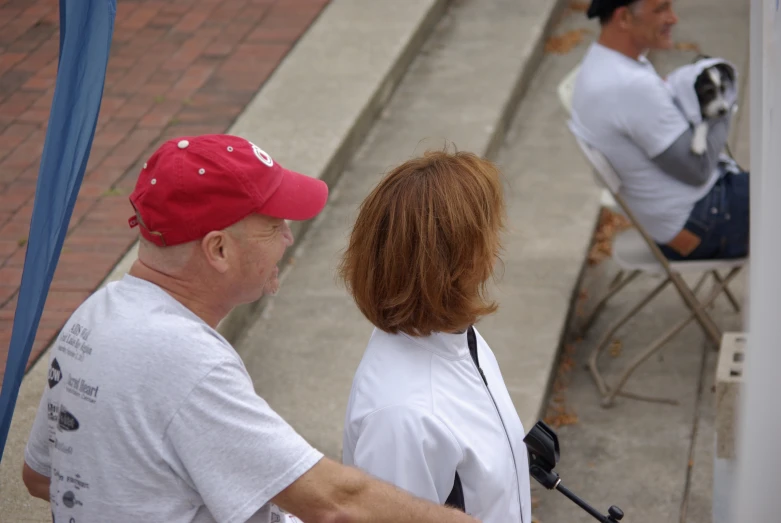 man and woman sitting on a chair in the street