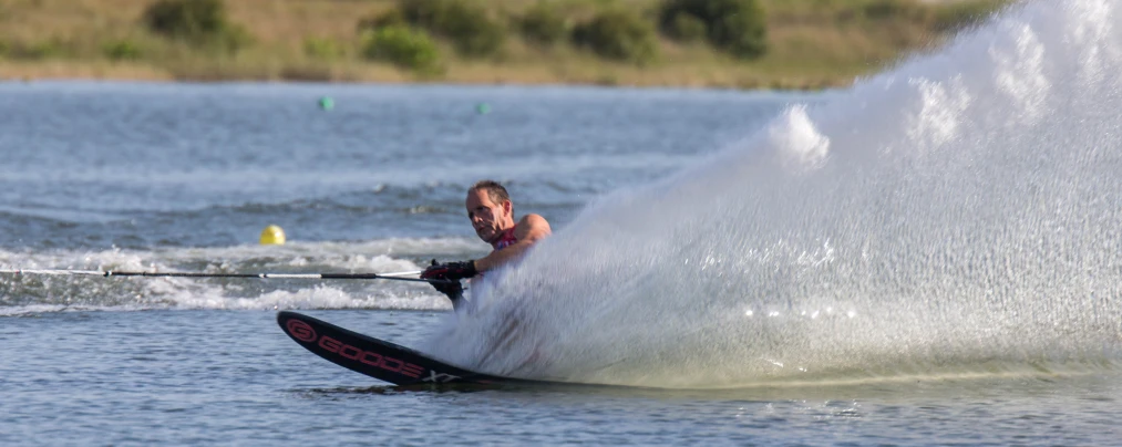 the man is water skiing behind a boat