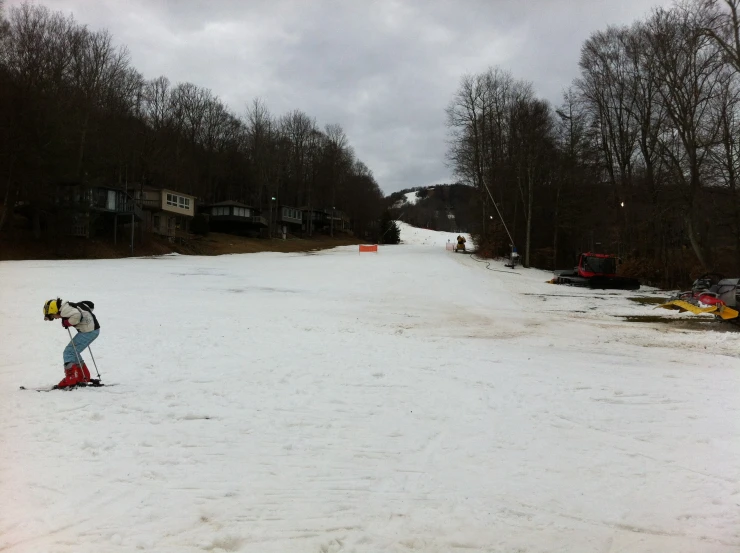 the person in a blue snow suit is standing on skis