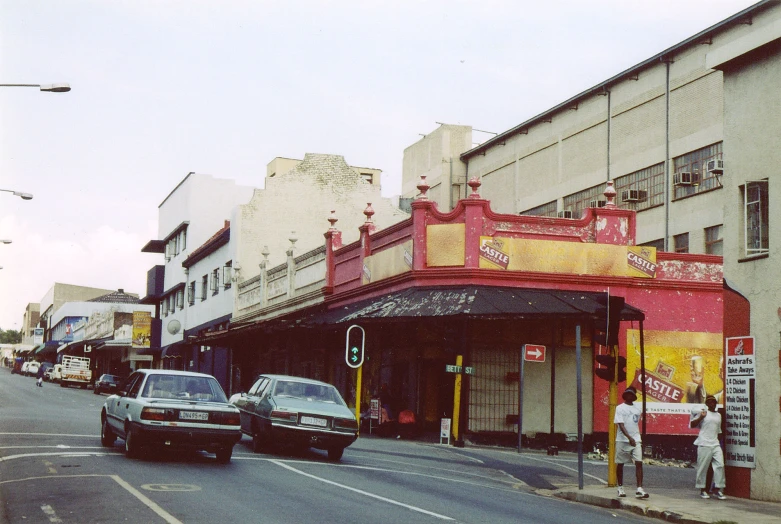 a row of parked cars sitting in front of a building on a city street