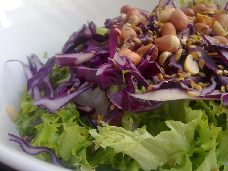 a white bowl filled with a salad and dressing