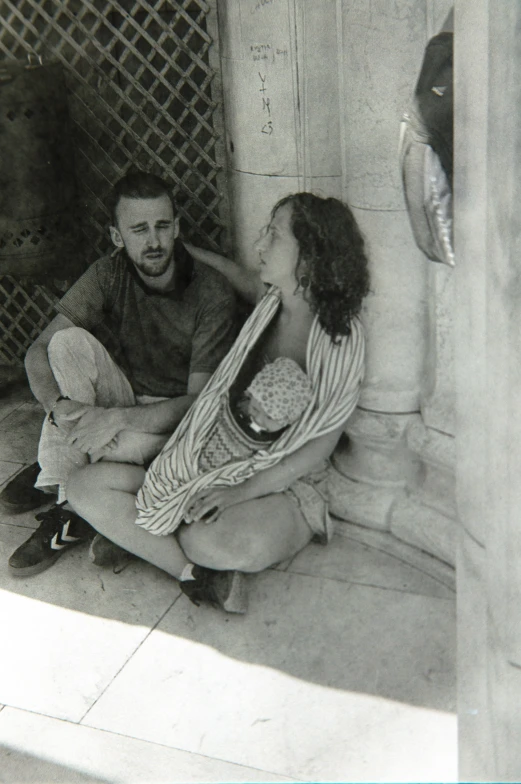 a man and a woman are sitting on the floor