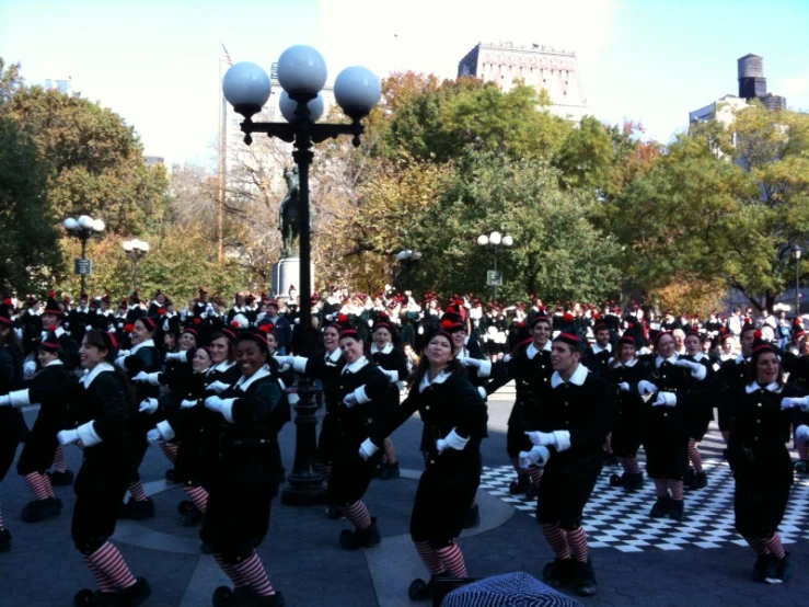 people dressed in costume are marching through the city