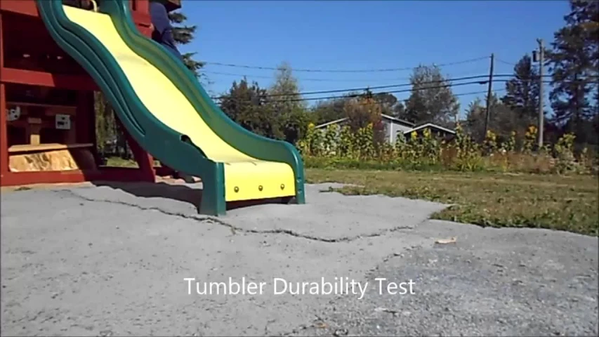 a play area with a slide in front of a barn