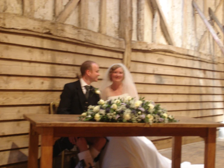 the bride and groom are sitting at their wedding table