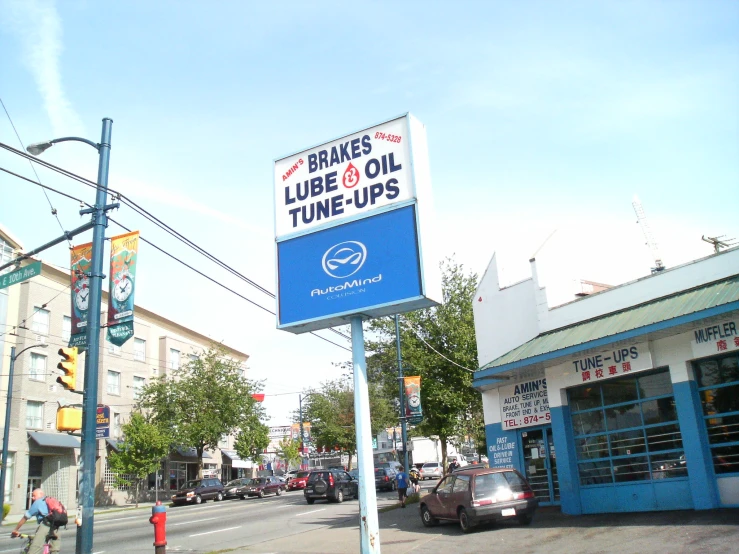 a sign on the side of a road next to a street light