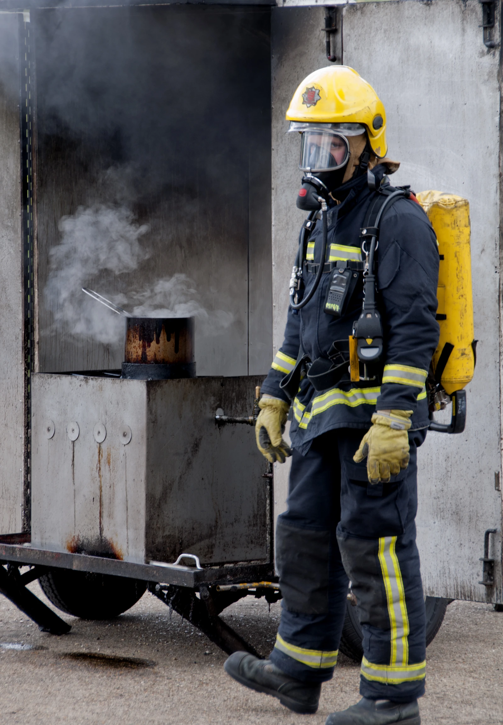 a firefighter is standing next to the cart in which he has been put out