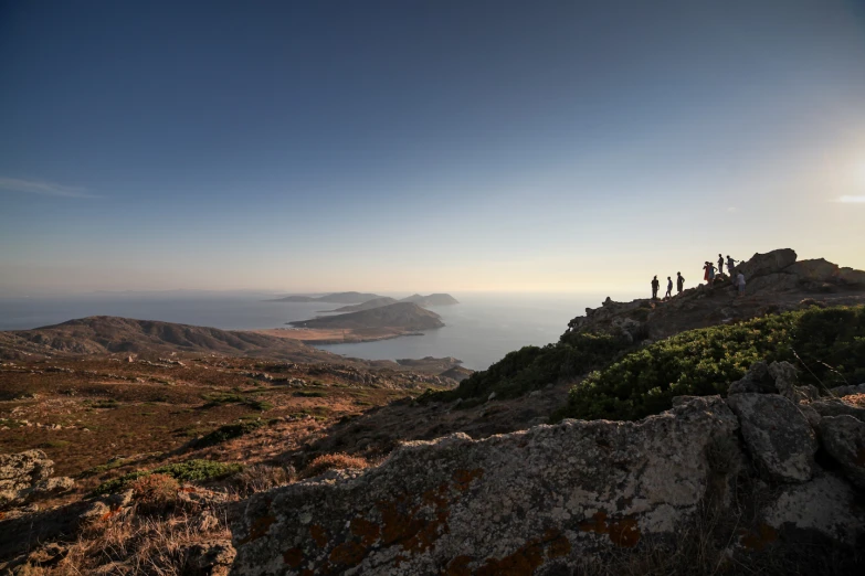 group of people standing on top of a hill