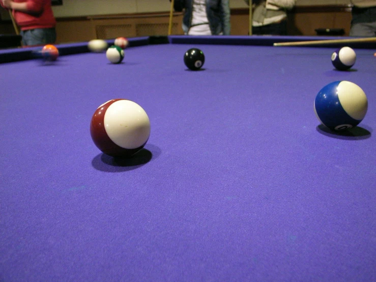 several billiards playing games on purple cloth