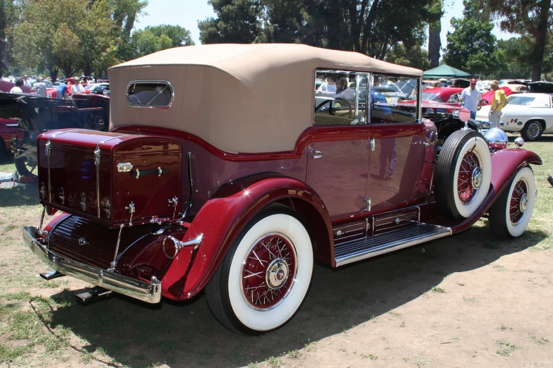 an old model of a classic car parked in the dirt