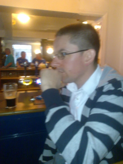 a guy drinking a beverage with glasses on it