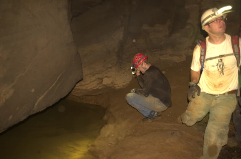 two men standing in the middle of an underground tunnel