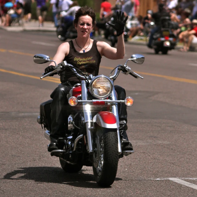 a man on a motor bike with a victory sign