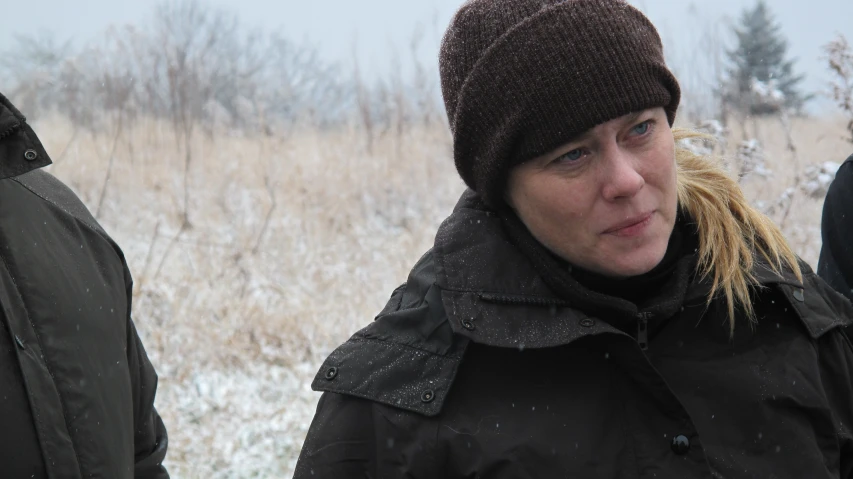 a woman standing outside with a winter coat on