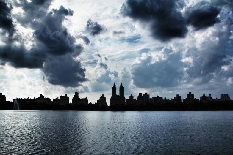 the water is serene, and there are clouds above