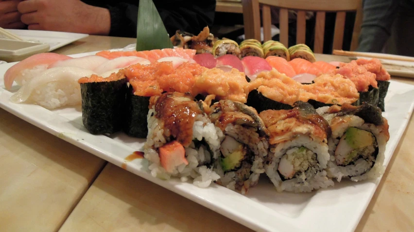 some assorted sushi with sauces on them