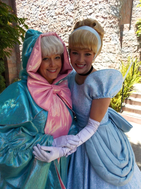 two woman dressed up like princesses and wearing bonnets