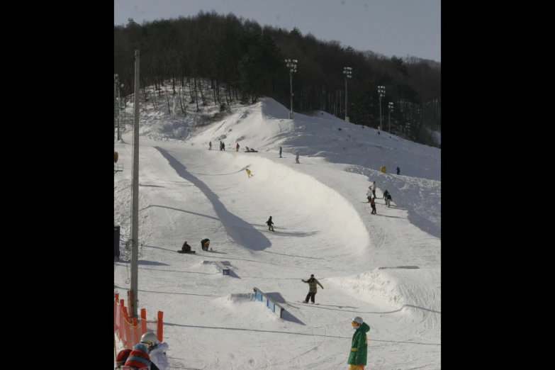 people are on the slopes in front of a ski lift