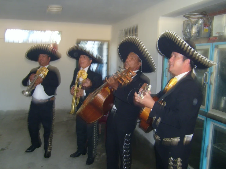three men in sombreros playing their instruments