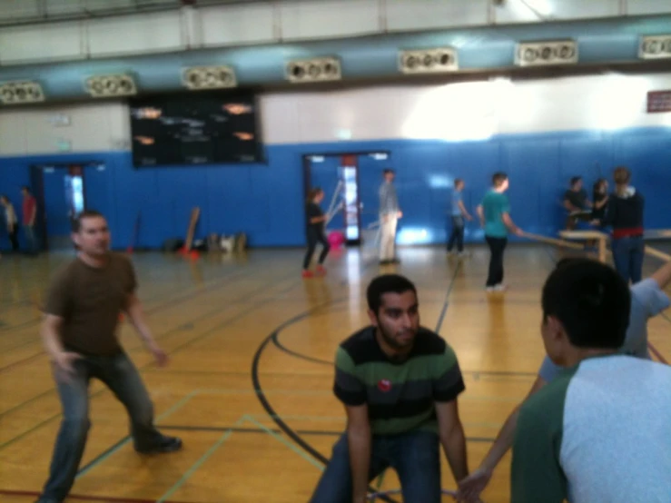 several men are playing a game of tennis on the court