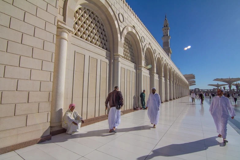 there are two men walking next to a building