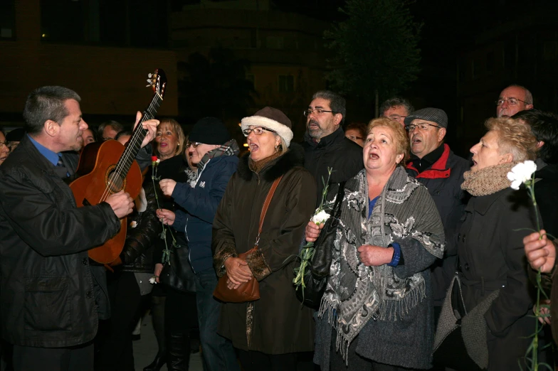 group of people standing together holding instruments in their hands