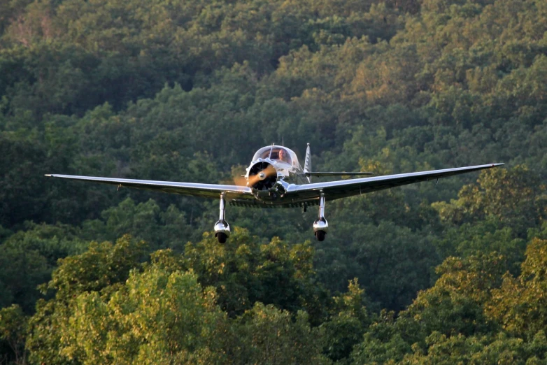 an older looking aircraft flies low in the sky