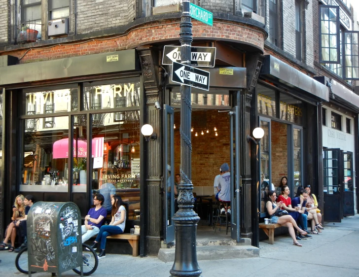 a storefront with a man on a bicycle in front