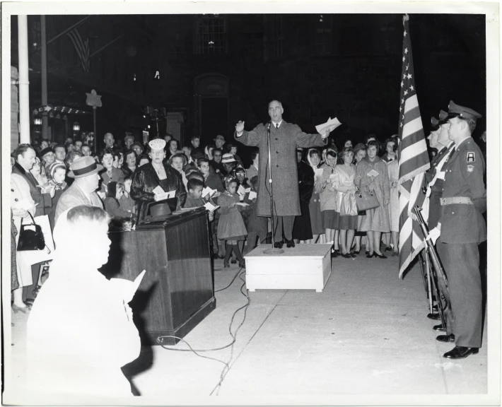 a man that is standing in front of a bunch of people