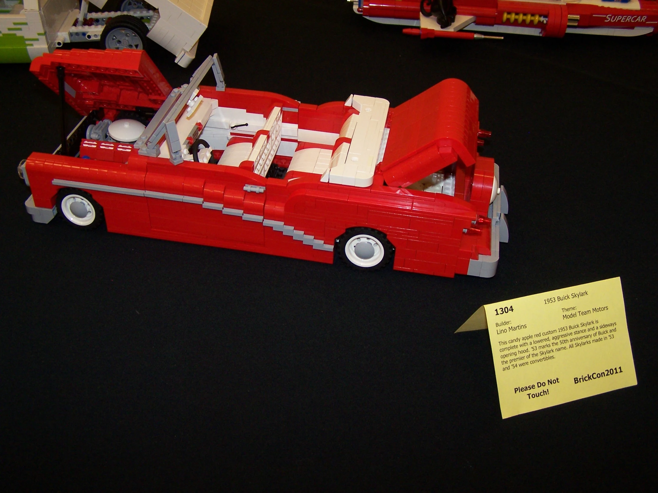 lego model of firetruck and driver with note on table