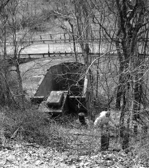 an old truck is sitting by the bridge