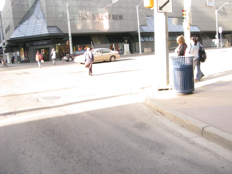 a woman on the sidewalk with her arms crossed