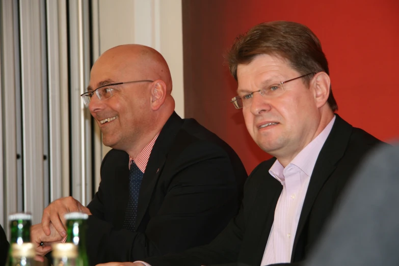 two people at a table talking and laughing