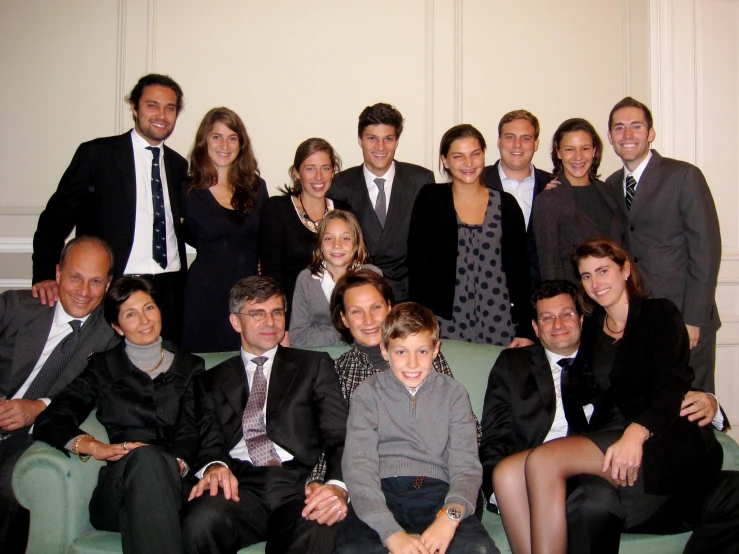 a large group of people are all smiling for a group picture