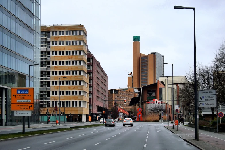 cars moving on an empty road between two buildings