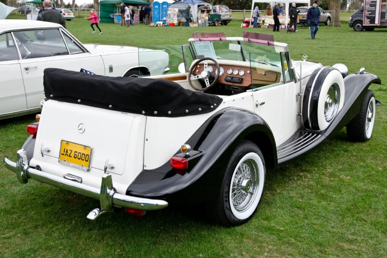 the old car is parked in the field