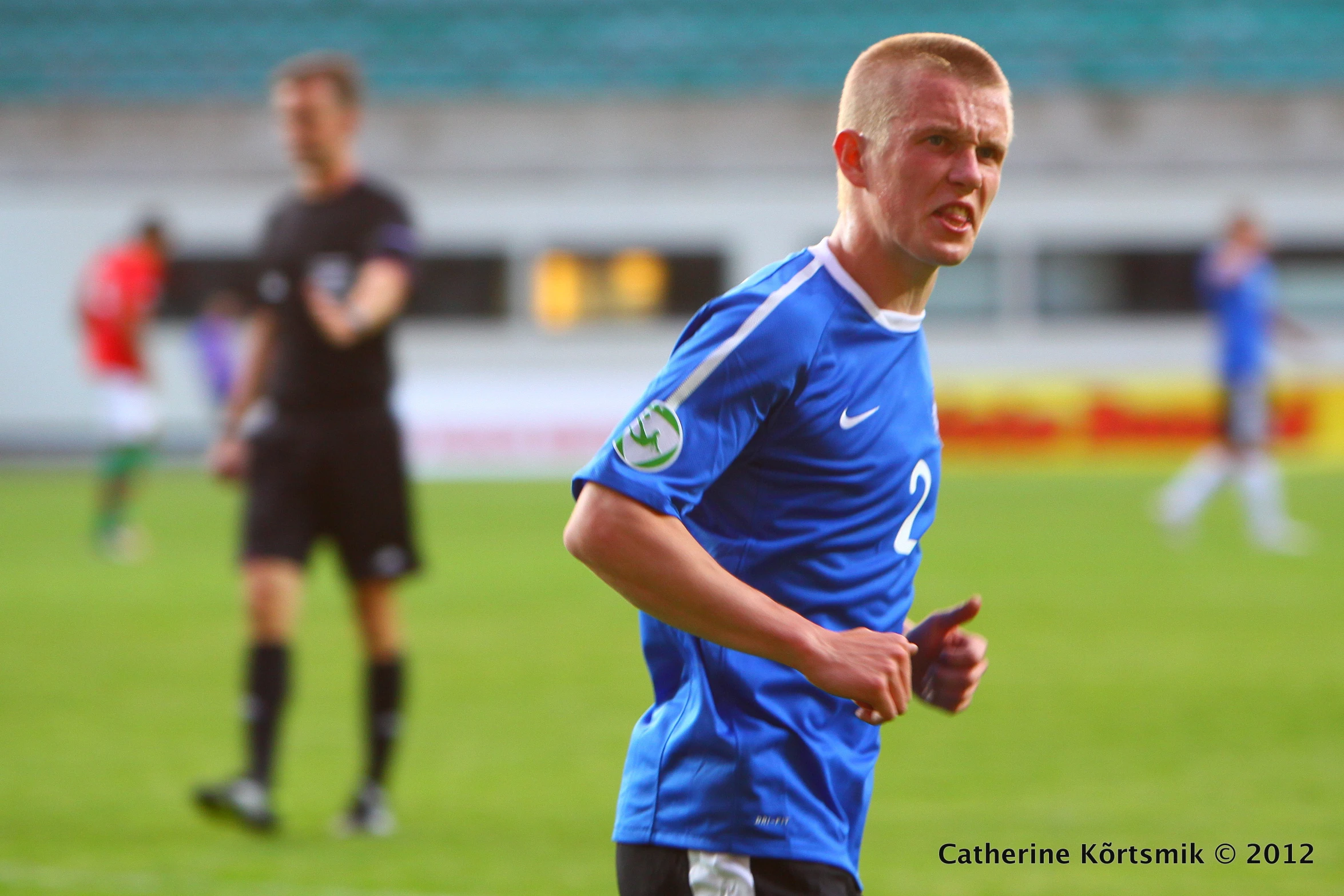 a young soccer player is running towards the ball