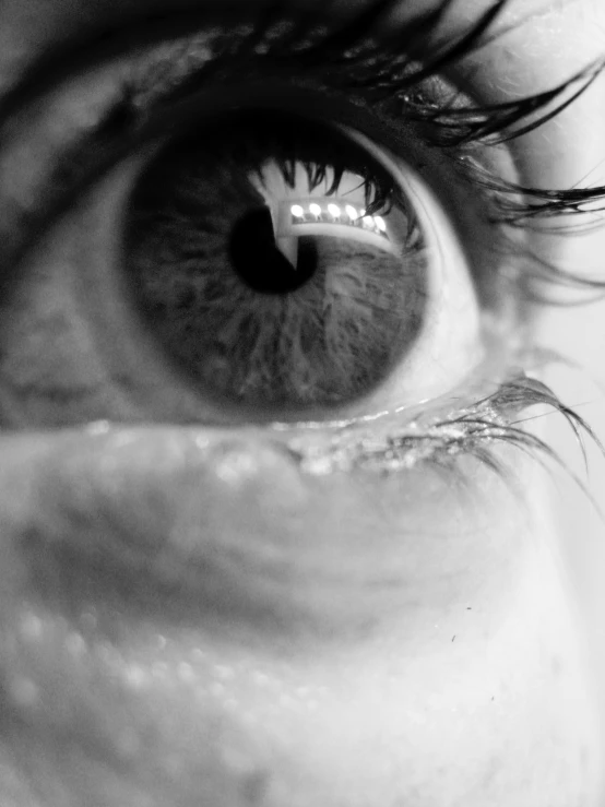 a man looking into his eye with long eyelashes