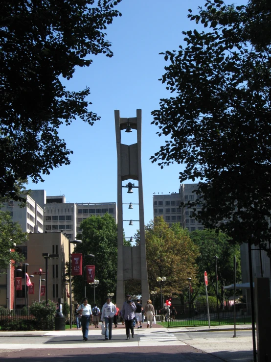 a very tall tower with a clock on top in the middle of a park