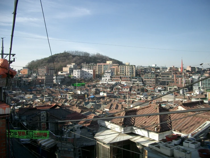 the view of city from a rooftop of an area with mountains