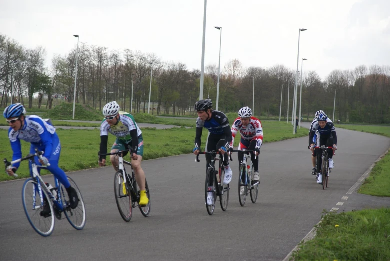 a group of people riding bikes down a pathway